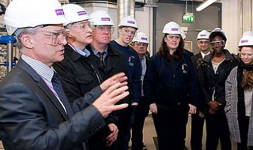 Colin Baines speaks to a group of apprentices on a tour of one of The University of Manchester facilities.